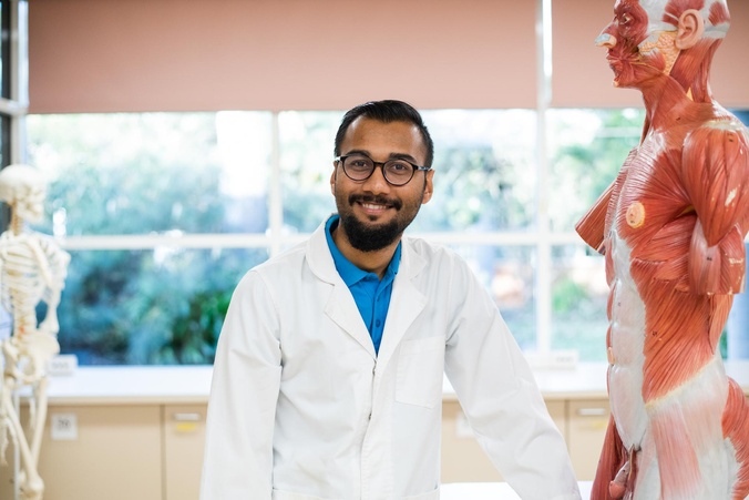 Nursing student with anatomy model