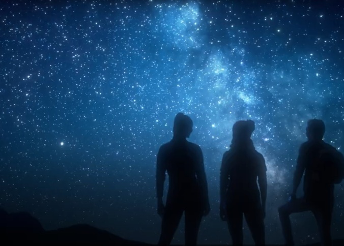 A starry sky with figures in silhouette