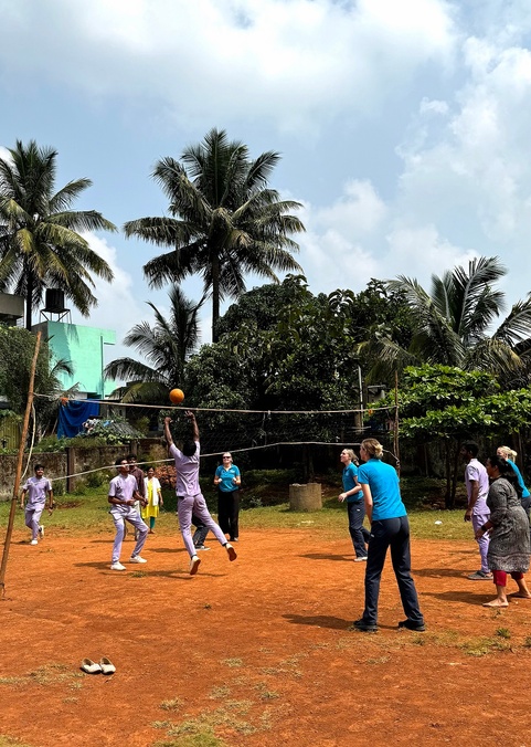 Students and healthcare workers playing volleyball