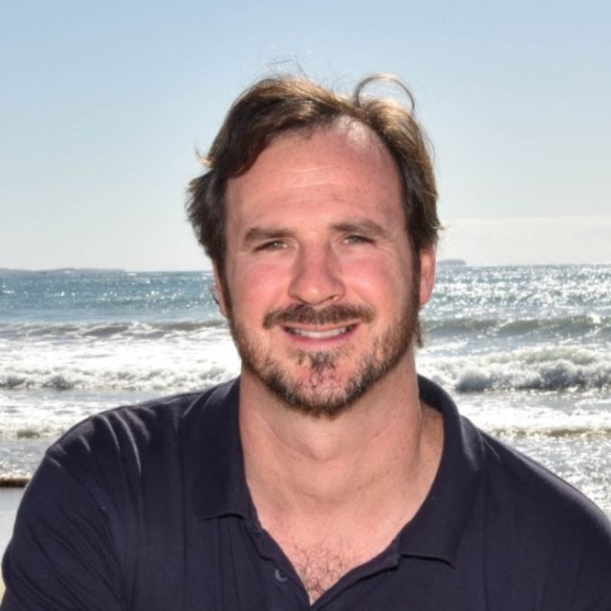 Portrait of Dr Daniel Harrison at beach