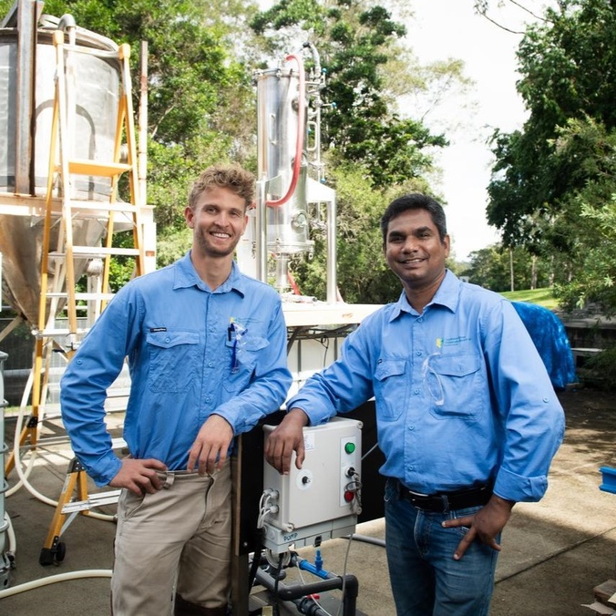 two men wearing blue long sleeve shirts looking at camera
