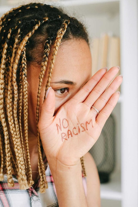 A young person holding a sign