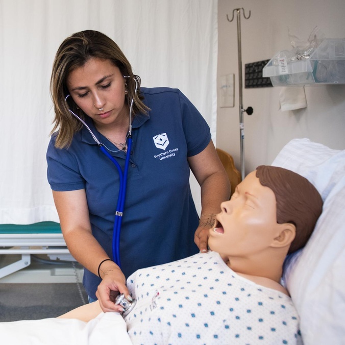 Student with health manequin