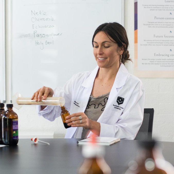 woman pouring herbal mixture