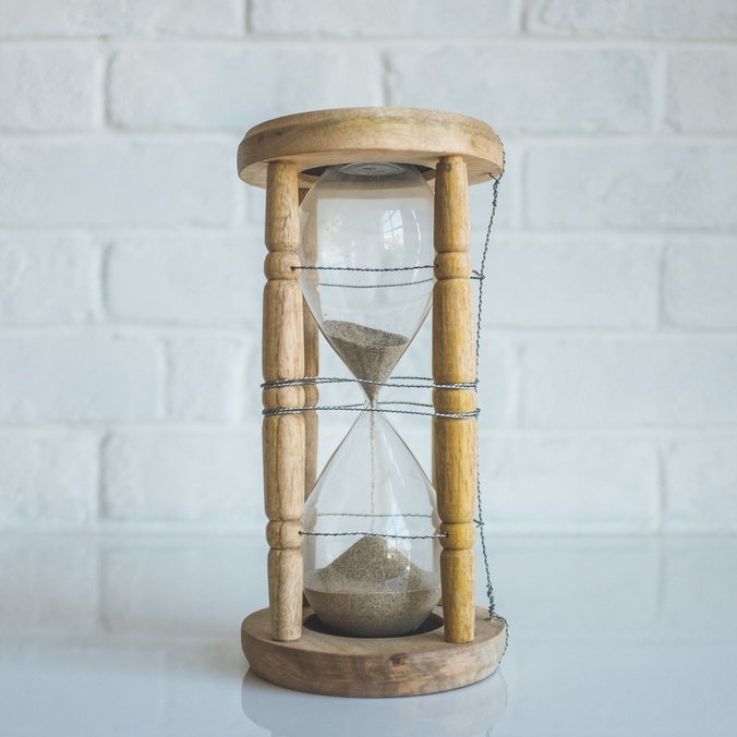 Clear hourglass with brown frame