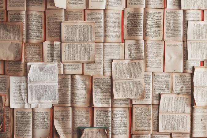 Pages of books laid down in various landscapes