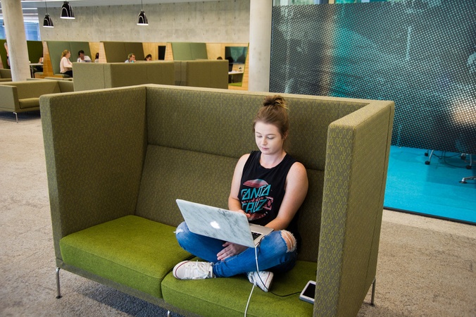 SCU Student on laptop in Lismore Campus Library