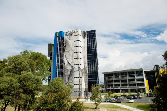 View from outside towards two multi-story buildings and a carpark
