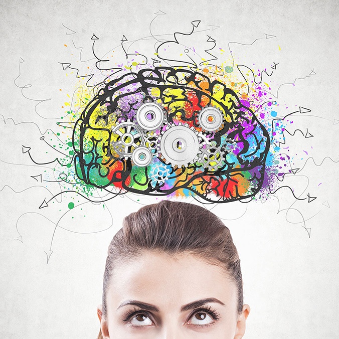 female looking up at comical brain drawing and it's colourful over activity