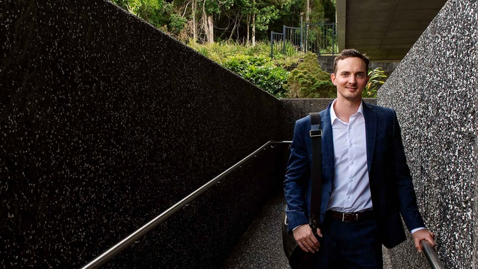 Law student graduate Tom Kershaw standing in front of the Southern Cross University Lismore campus Learning centre