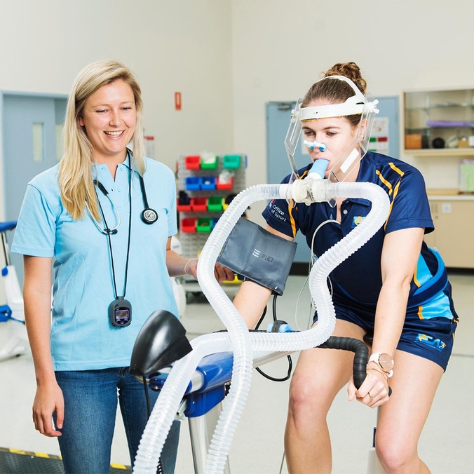 Exercise Science Student on bike with oxygen mask doing testing