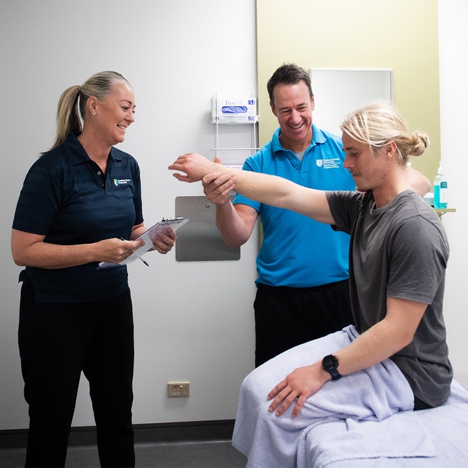 Osteopathy student getting taught by supervisor at GC health clinic