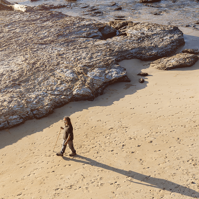 Kombumerri man, John Bartie-Graham walking on the beach
