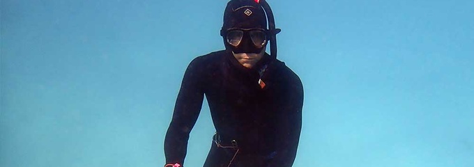 Scuba diver holding sea cucumber