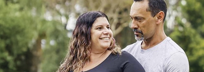 Pregnant woman being hugged by partner