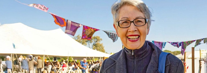 Jenny Dowell OAM at an event with tents in background