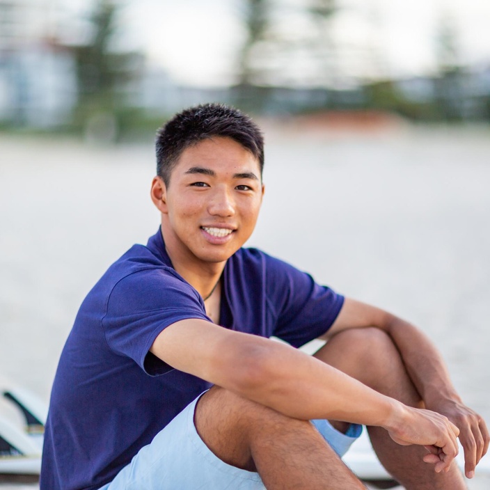 student sitting at beach
