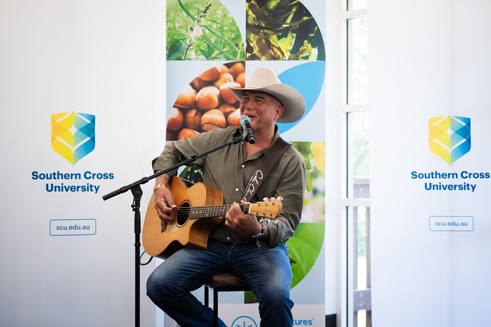 A man singing and playing the guitar