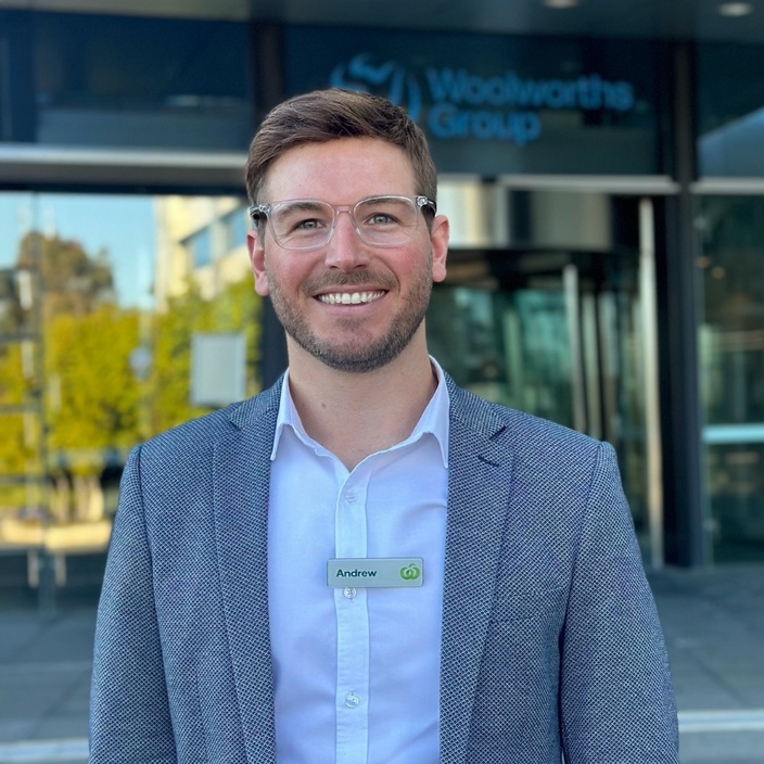 MBA graduate Andrew Nichols stands in front of the Woolworths Group offices in Sydney