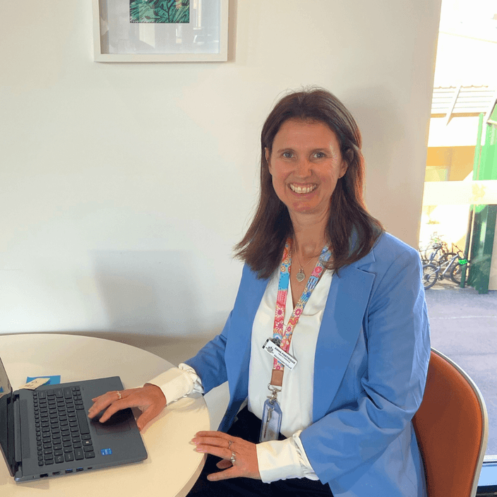 Author Anna Partridge sits in front of a laptop