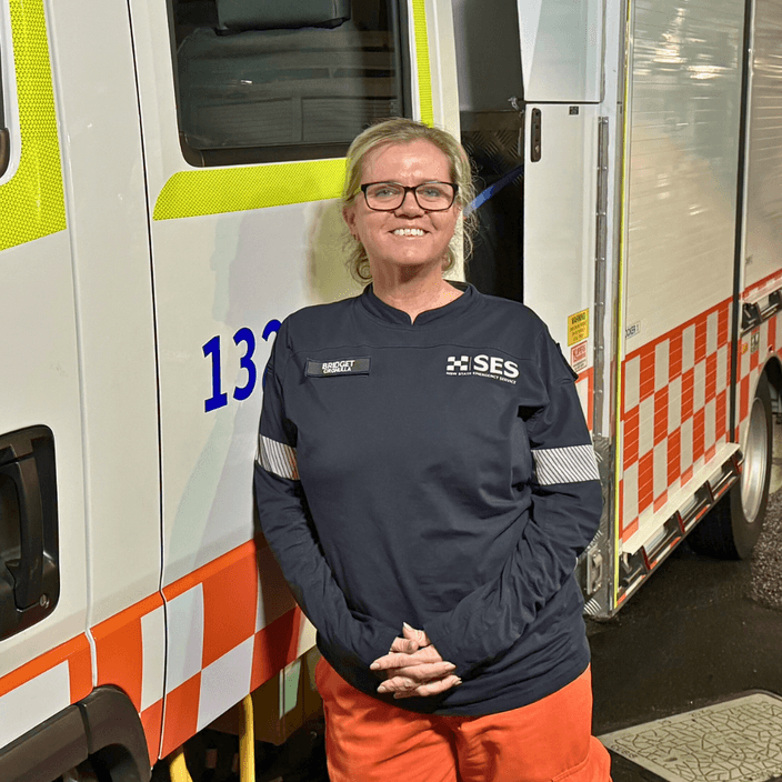 SES Deputy Unit Controller Bridget Clark stands in front on a State Emergency Services vehicle