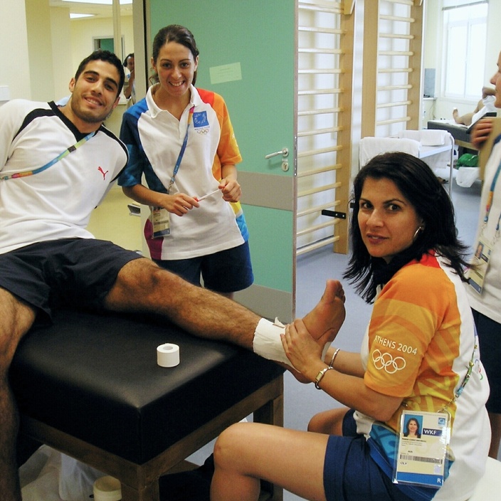Dr Maria Constantinou treats an athlete at Athens Olympic Games in 2004
