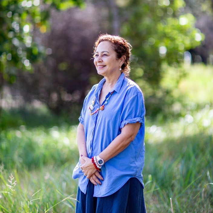 Nicole Tujague PhD stands in nature