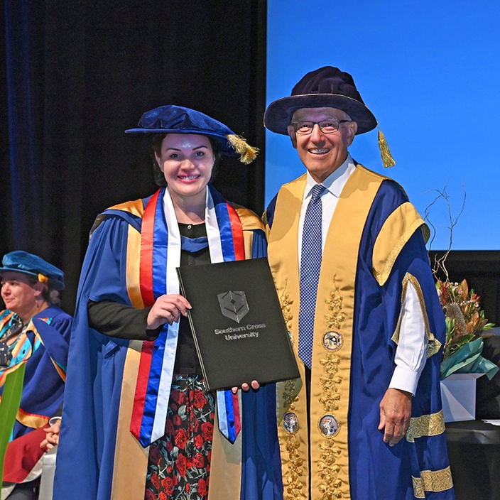 Dr Allyson Wilson receiving graduation certificate at Coffs Harbour ceremony