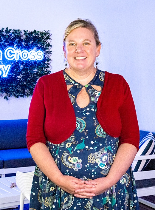 A woman in a red cardigan and dress