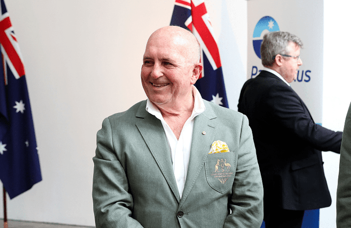 A bald-headed man in a Commonwealth Games jacket