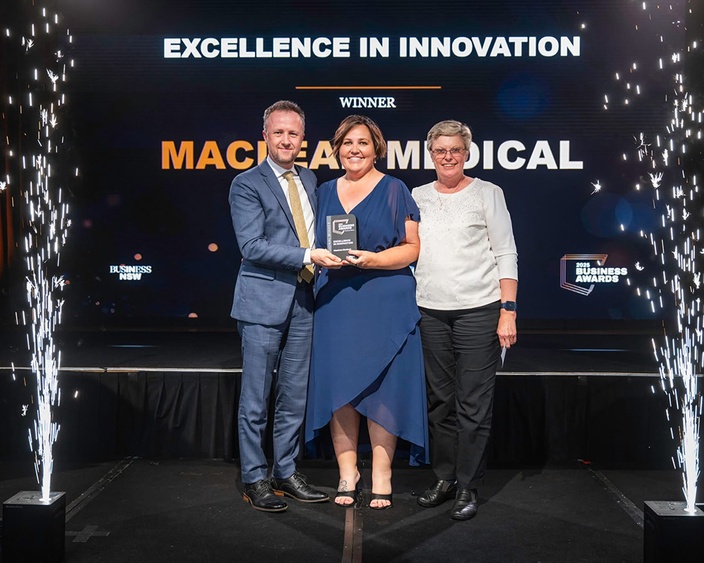 Haley Hodgson receiving award at Northern NSW Business Awards, on stage with Ben Roche