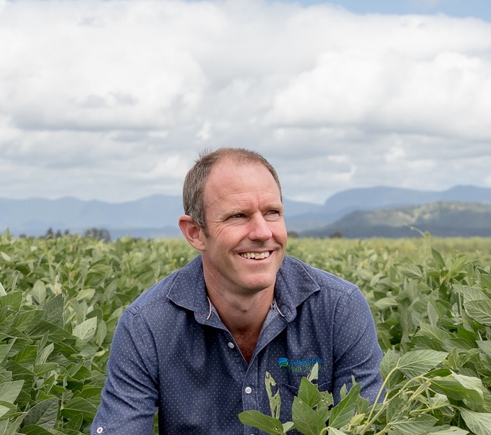 A man in a field of green crops
