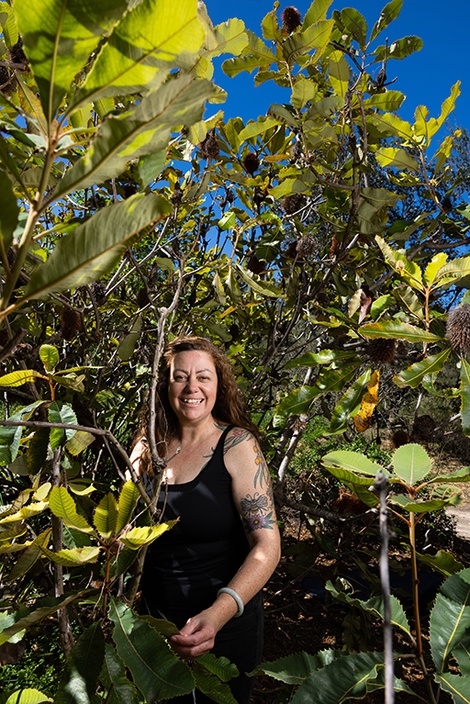 A woman standing next to a tree