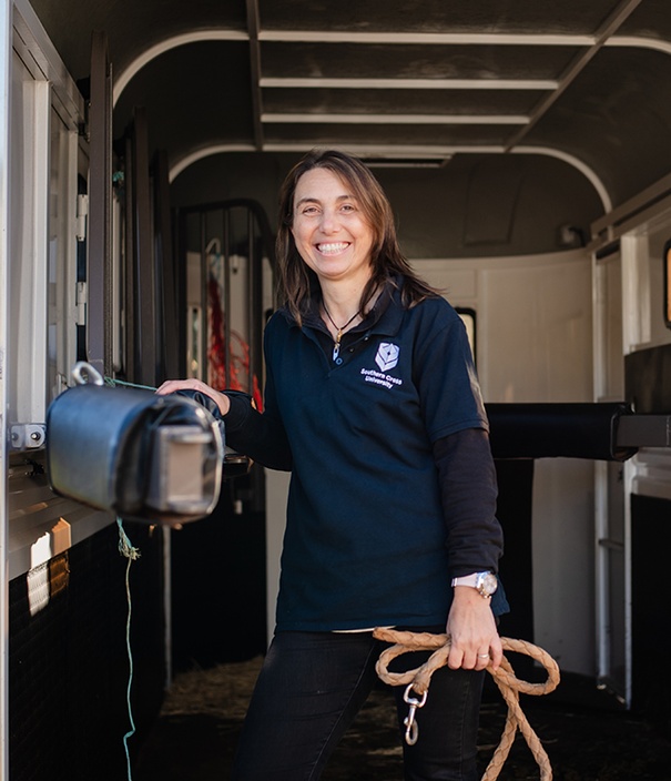 A woman in a horse trailer