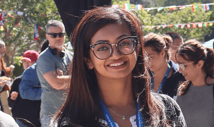 Woman with glasses smiling at camera