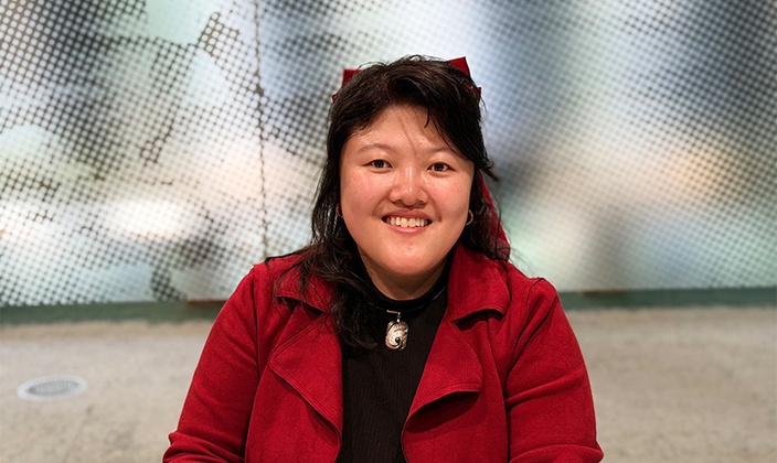 Woman in red jacket smiling at camera