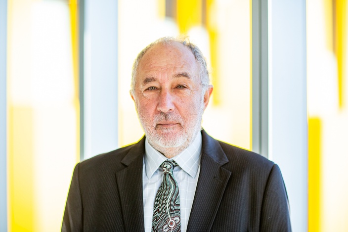 David Heilpern in suit with yellow building in background