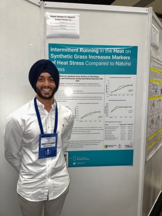 Gurpreet standing in front of poster about his research