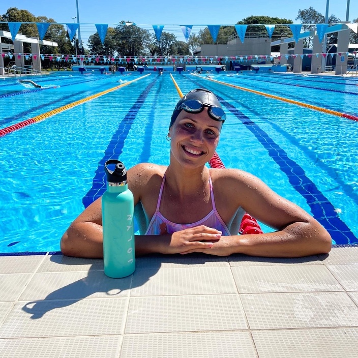 Swimmer Moesha Johnson poses in a pool