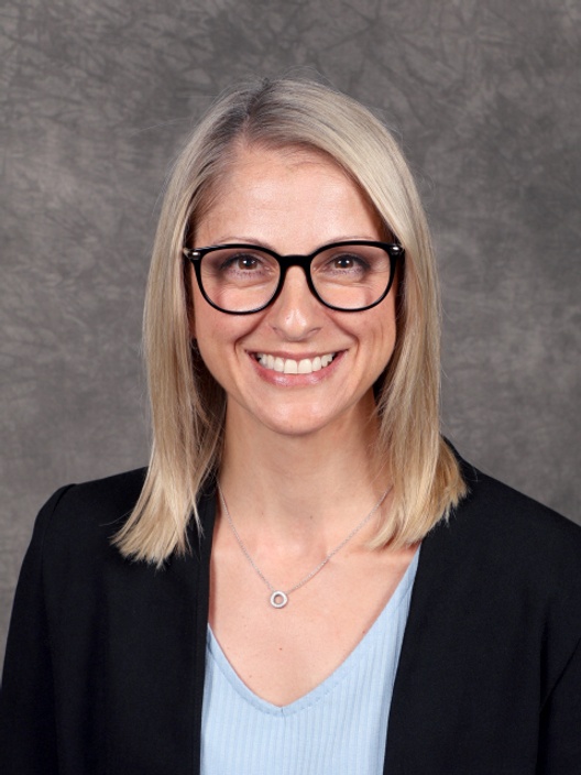 Headshot of blonde woman with glasses smiling