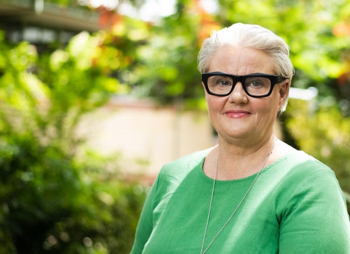 Portrait of Professor Mary Spongberg with green trees in background