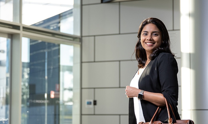 Ishitah Shah, Master of Professional  Accounting graduate.walking into an office building