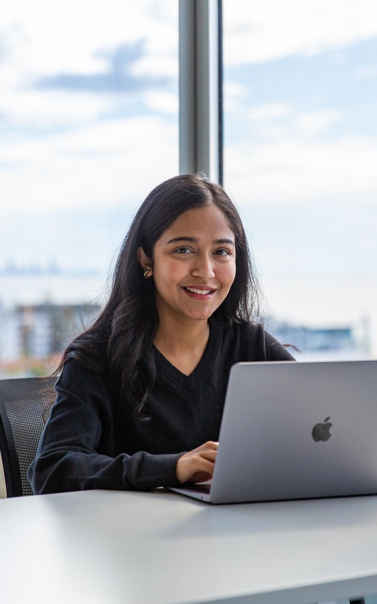 Student at a desk using a laptop