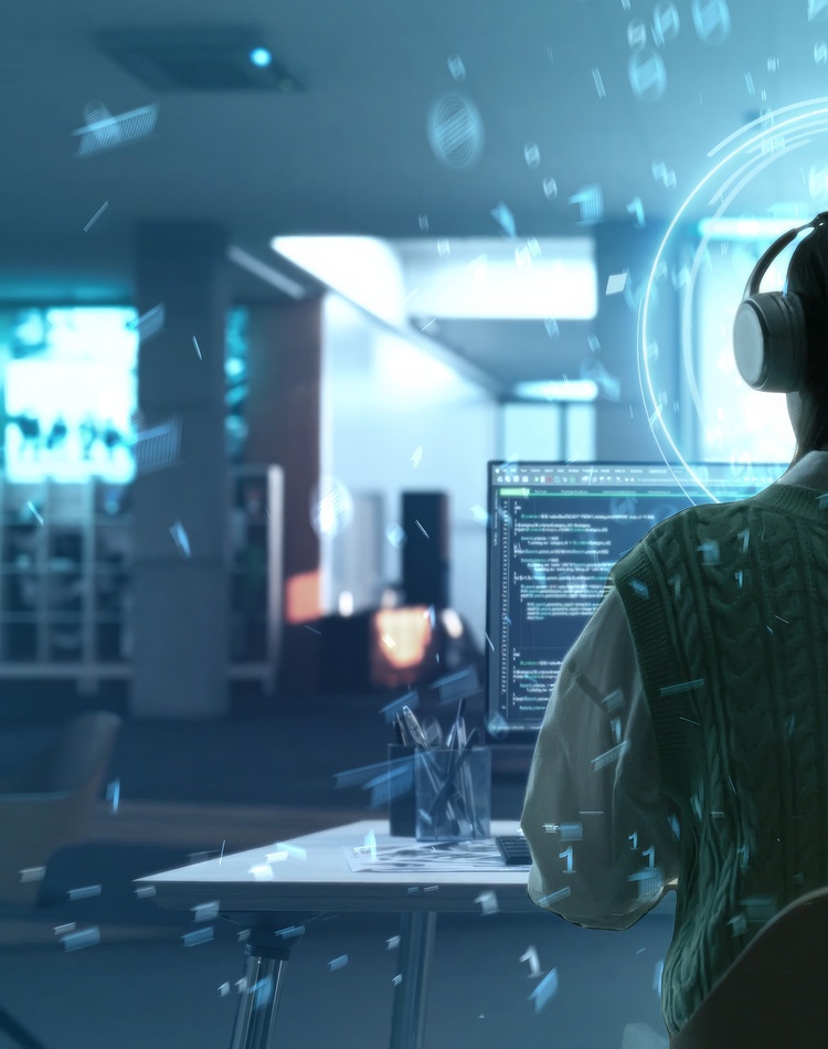 person sitting infront of computer with headphones