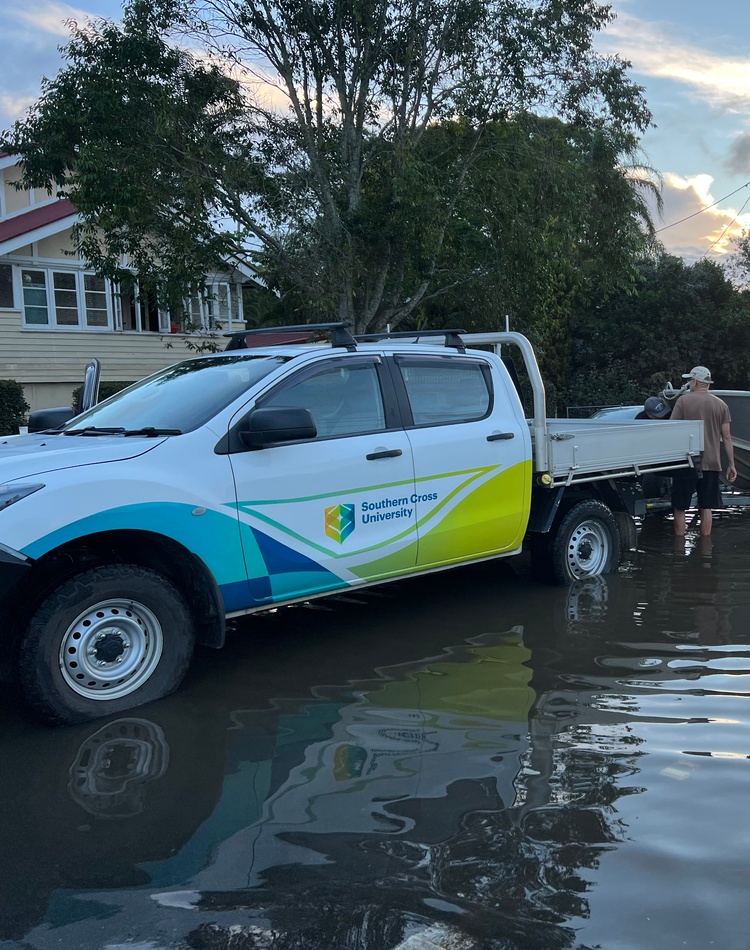 Professor Bradley Eyre loading the University research boat from Lismore flood waters