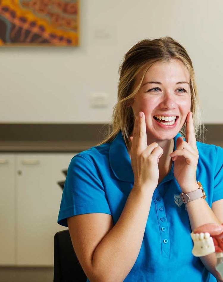 Speech pathology student with client