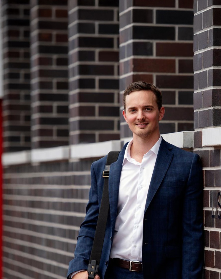 law student standing by a wall