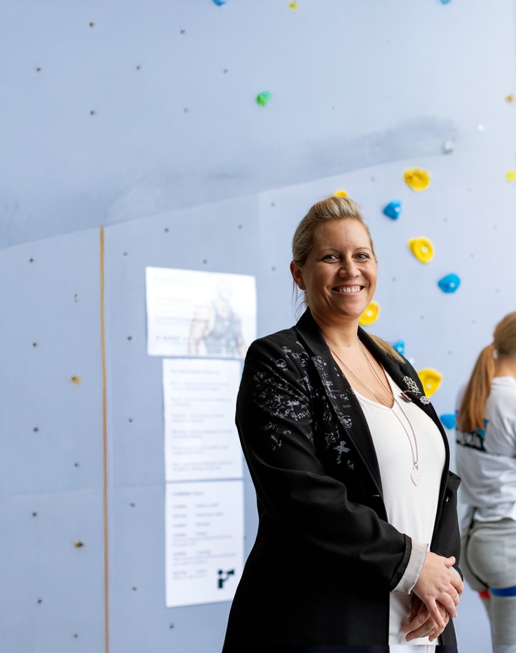 teacher with students in wall climbing exercise