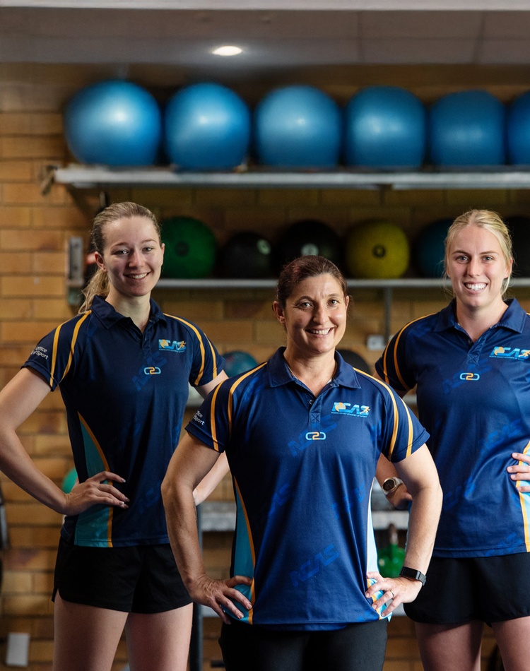 three females in gym