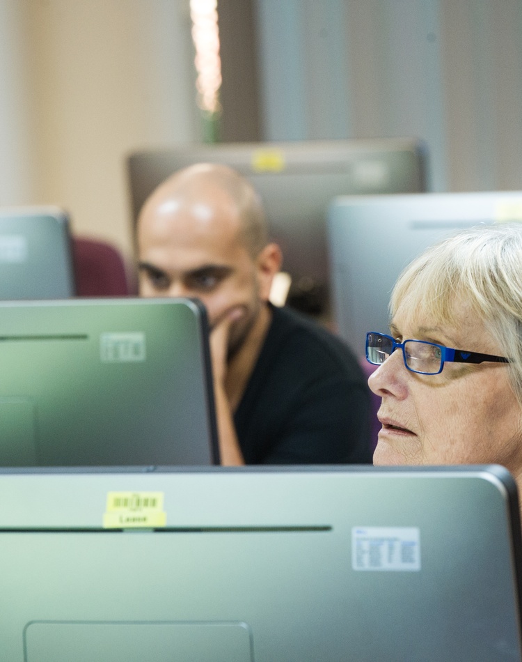 Two students sitting in front of computers